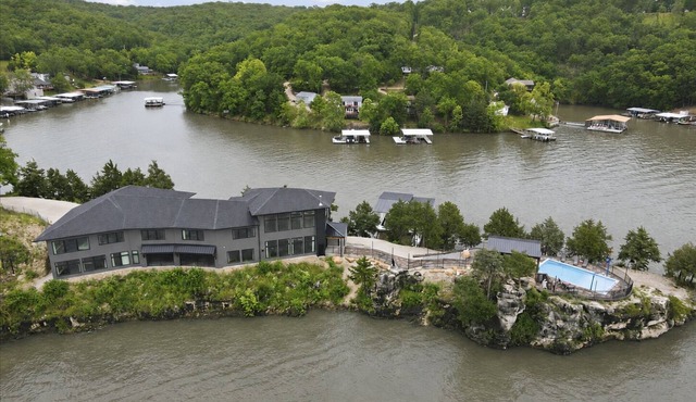 Expansive Lakefront Estate with Private Pool, Dock, 2 Slips, & Movie Theater at 43mm